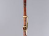 a wooden clarinet with a black top and gold trim