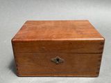 an old wooden box with a lock on top of it