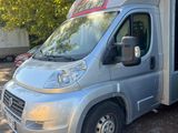 an image of a silver camper van parked in a parking lot