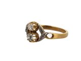 a close up of a gold and diamond ring on a white background
