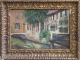 an oil painting of a building and a river in a gold frame