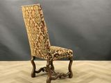 a chair with a floral upholstered seat on a wooden floor