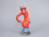 figurine of a man with a hat and glasses on his head