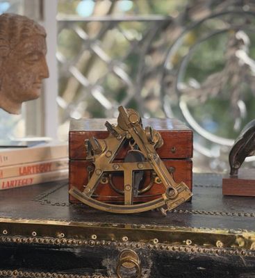 a wooden box with a brass compass on top of it