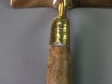 a wooden handle with a metal handle on a table