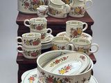 a lot of dishes and cups sitting on a table