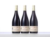 three bottles of wine sitting on top of a table