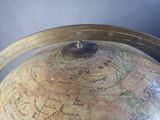 a large globe with a clock on top of it