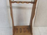 a small wooden rack with four pairs of shoes on it