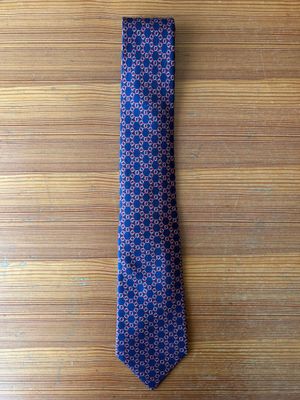 purple and blue patterned tie on a wooden table