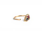 a close up of a gold ring with a multi colored stone