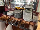 a lot of plates and utensils on a table