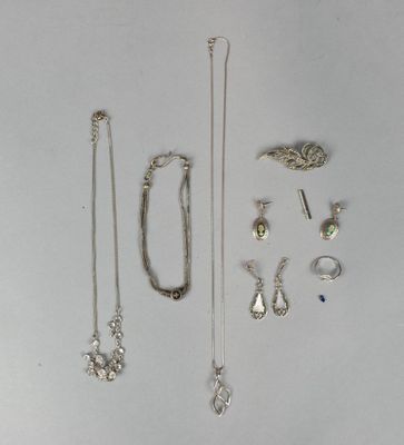 several different types of jewelry are displayed on a white surface