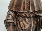 wooden statue of a man with a hat and a cane