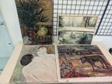 three paintings on a table with a plant in the background