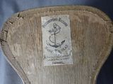 an old wooden chair with a label on it