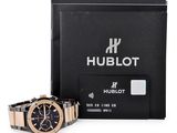 the hublot watch is next to a black box with a credit card
