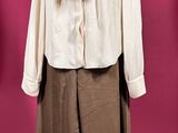 a white shirt and brown pants on a mannequin