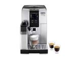 une machine à café argentée posée à côté d'une tasse de café