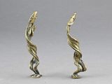 pair of brass figurines of a bird and a fish
