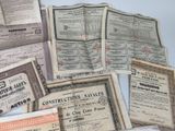 several old certificates are stacked on top of each other on a table