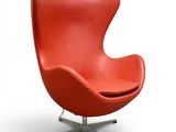 an image of a red chair with a metal base on a white background