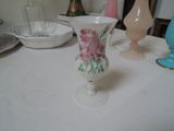 a white table topped with vases and plates