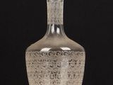 an image of a clear glass bottle sitting on top of a wooden table