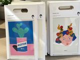 two boxes with a picture of a woman on them sitting on a table