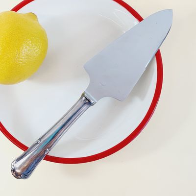 a plate with a knife and a lemon on it