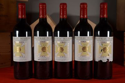 four bottles of wine are lined up on a table