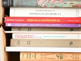 a box full of books that are stacked on top of each other