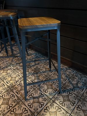 two stools sitting on a tiled floor in a room