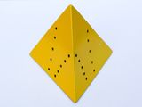 a yellow box with holes in it on a white surface