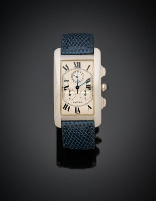 a silver and blue watch with roman numerals on a black background