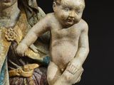 an old statue of a woman holding a baby on her lap