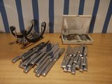 a box of knives and a pair of scissors on a table