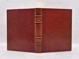 a brown leather book with a bookmark on the front of it