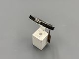 a small white box with a knife on top of it