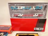 a box of assorted toy trains sitting on a table