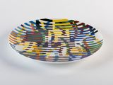 a multicolored bowl sitting on a white surface