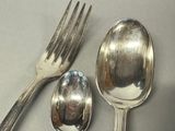 two spoons and a fork sitting on a table