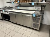 a kitchen with a lot of stainless steel appliances in it