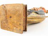 a small wooden box with a statue inside of it