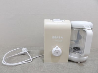 a small blender sitting on a table next to a wall