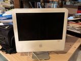 an apple desktop computer sitting on top of a wooden desk
