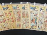 a lot of comic books on a black table