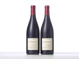 two bottles of red wine sitting next to each other on a table