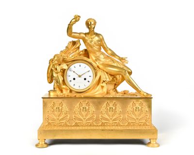 une horloge en or surmontée d'une statue
