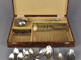 a lot of silver spoons and spoons in a case